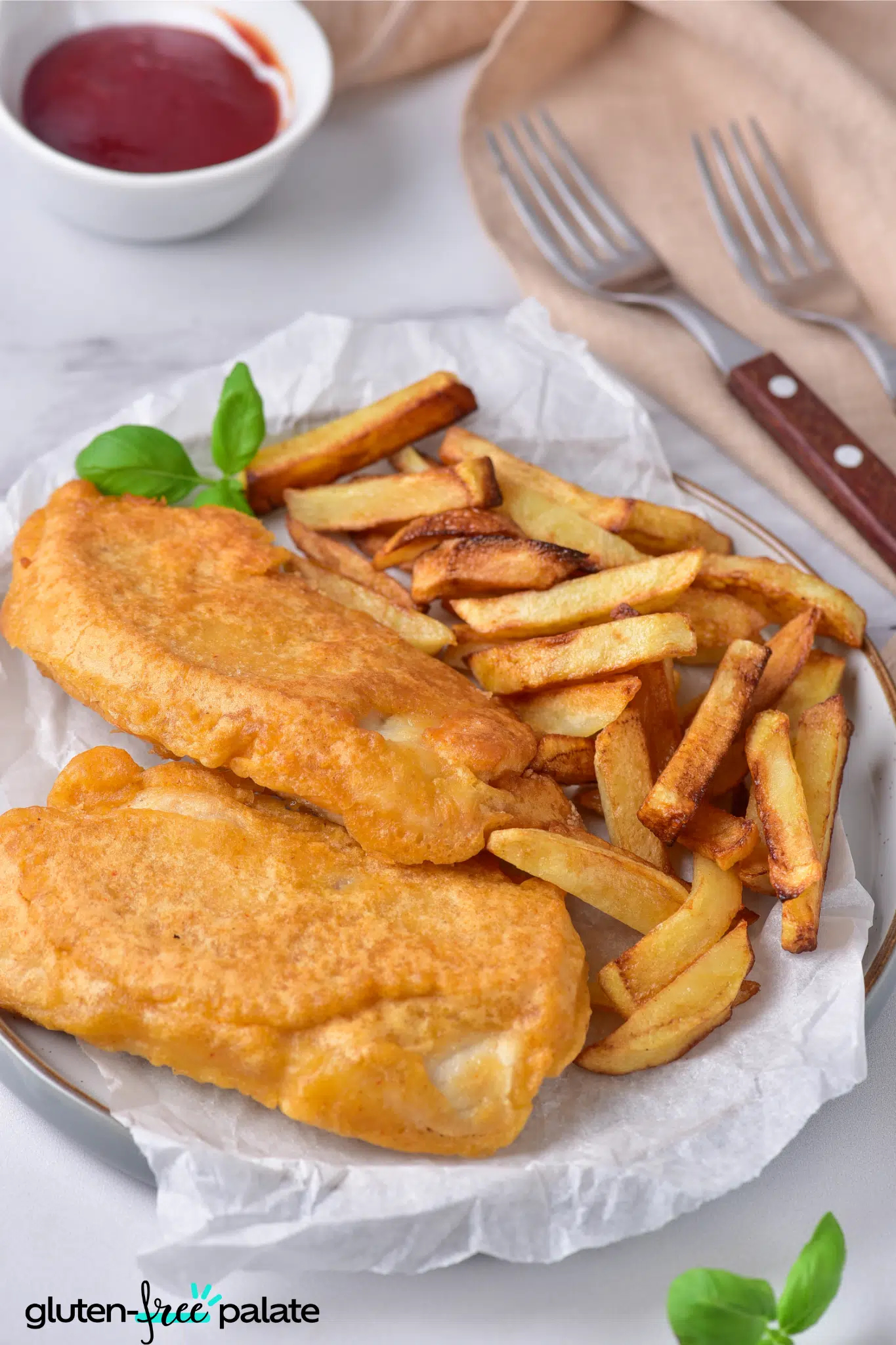 gluten-free fish and chips on a plate with sauce