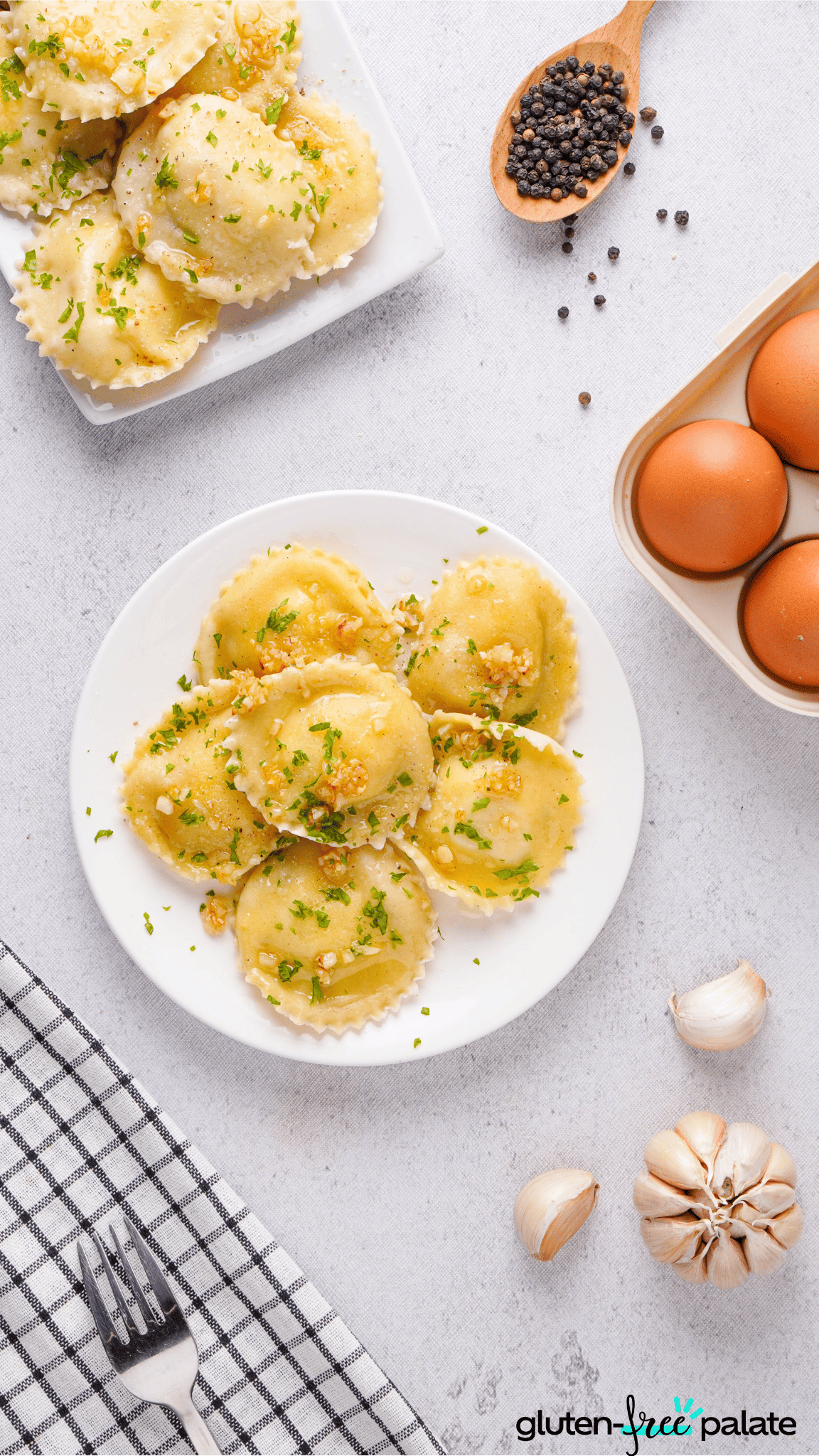 gluten-free ravioli on a white plate with eggs, peppercorns and garlic cloves.