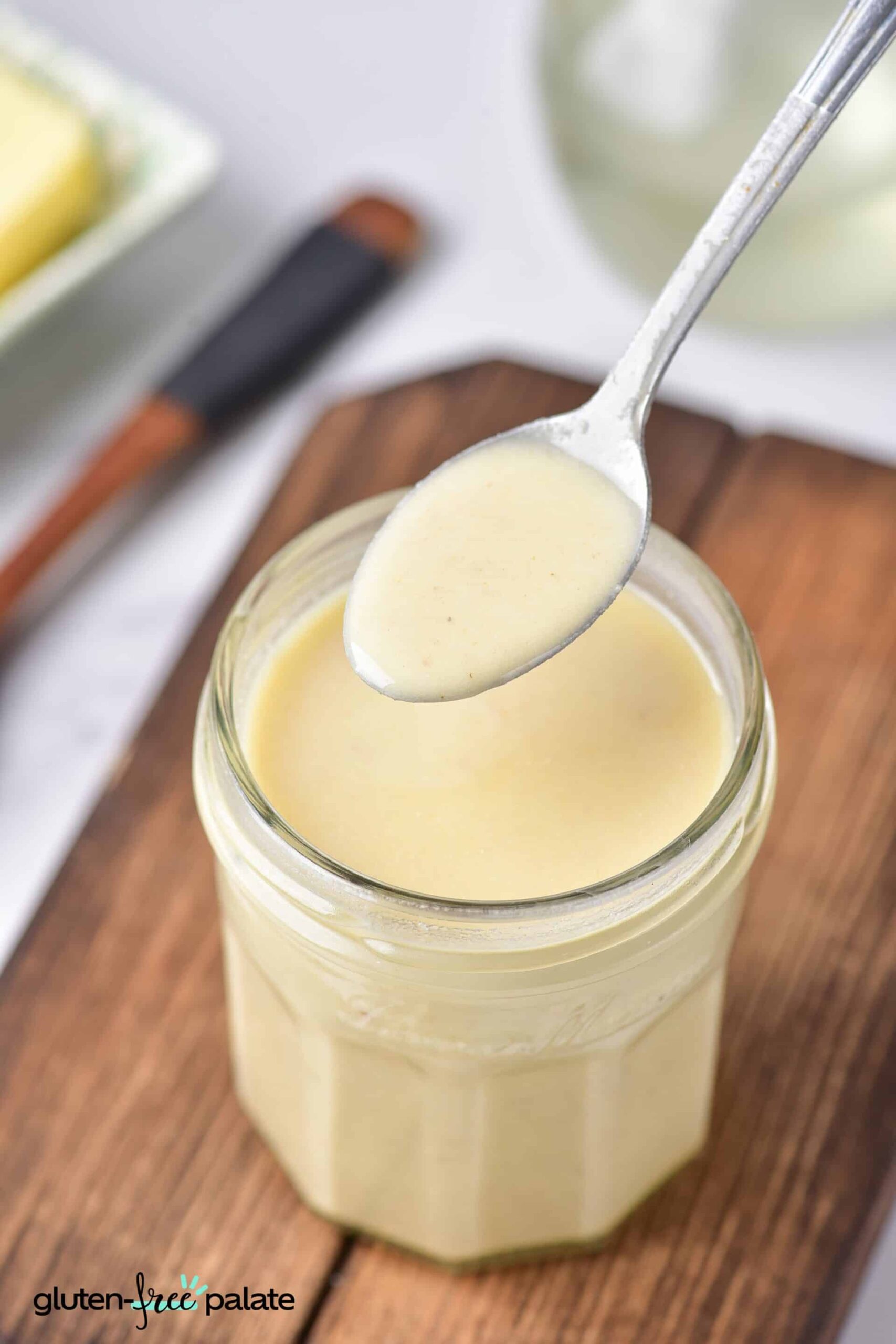 gluten-free roux in a jar and a silver spoon showing the consistency