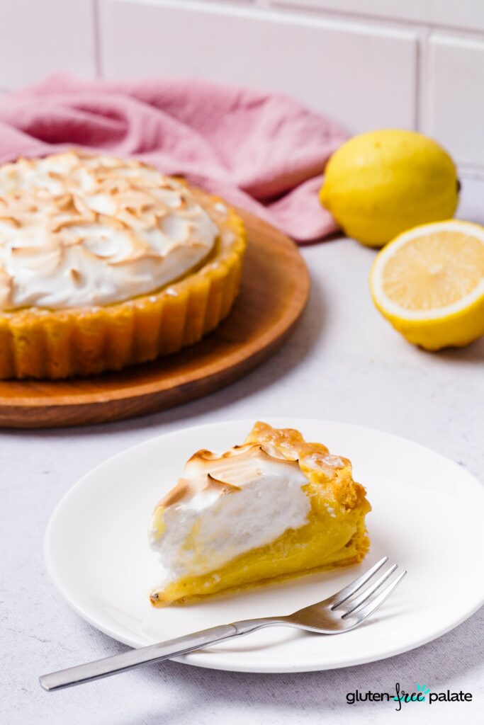 Gluten-free lemon meringue slice on a white plate.
