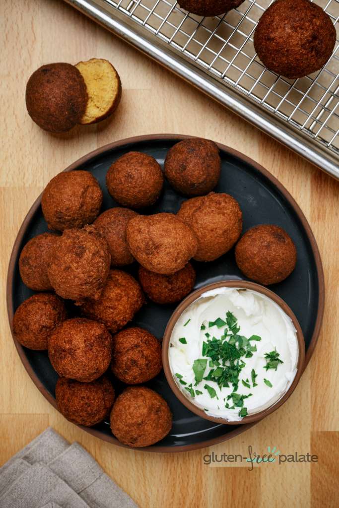 Gluten-free hush puppies in a black plate.