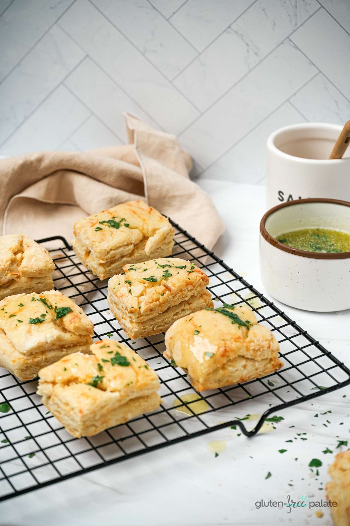 Gluten-Free Cheddar Biscuits on a black cooling rack.