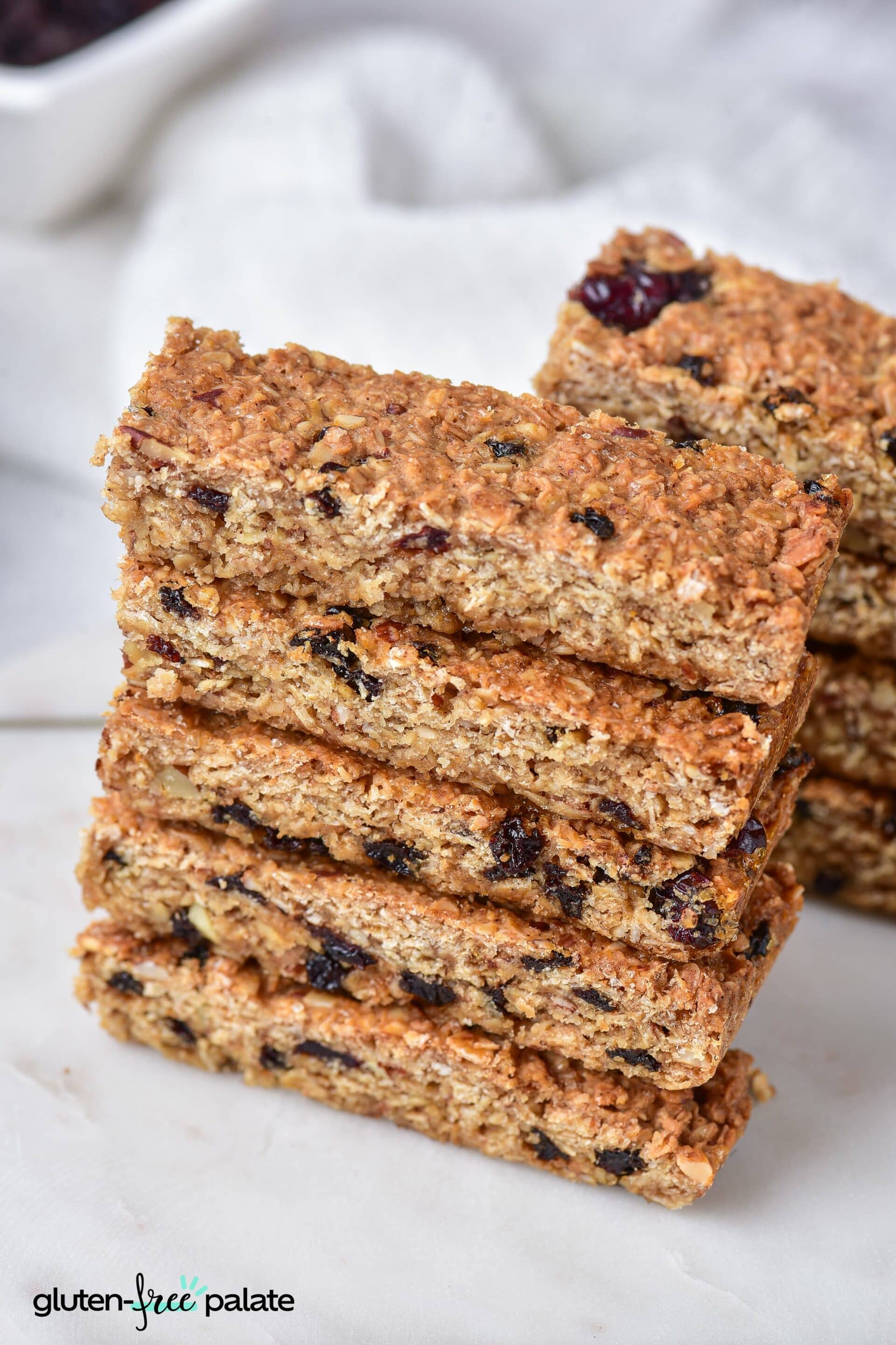 Gluten-free granola bars stacked on top of one another in two piles.