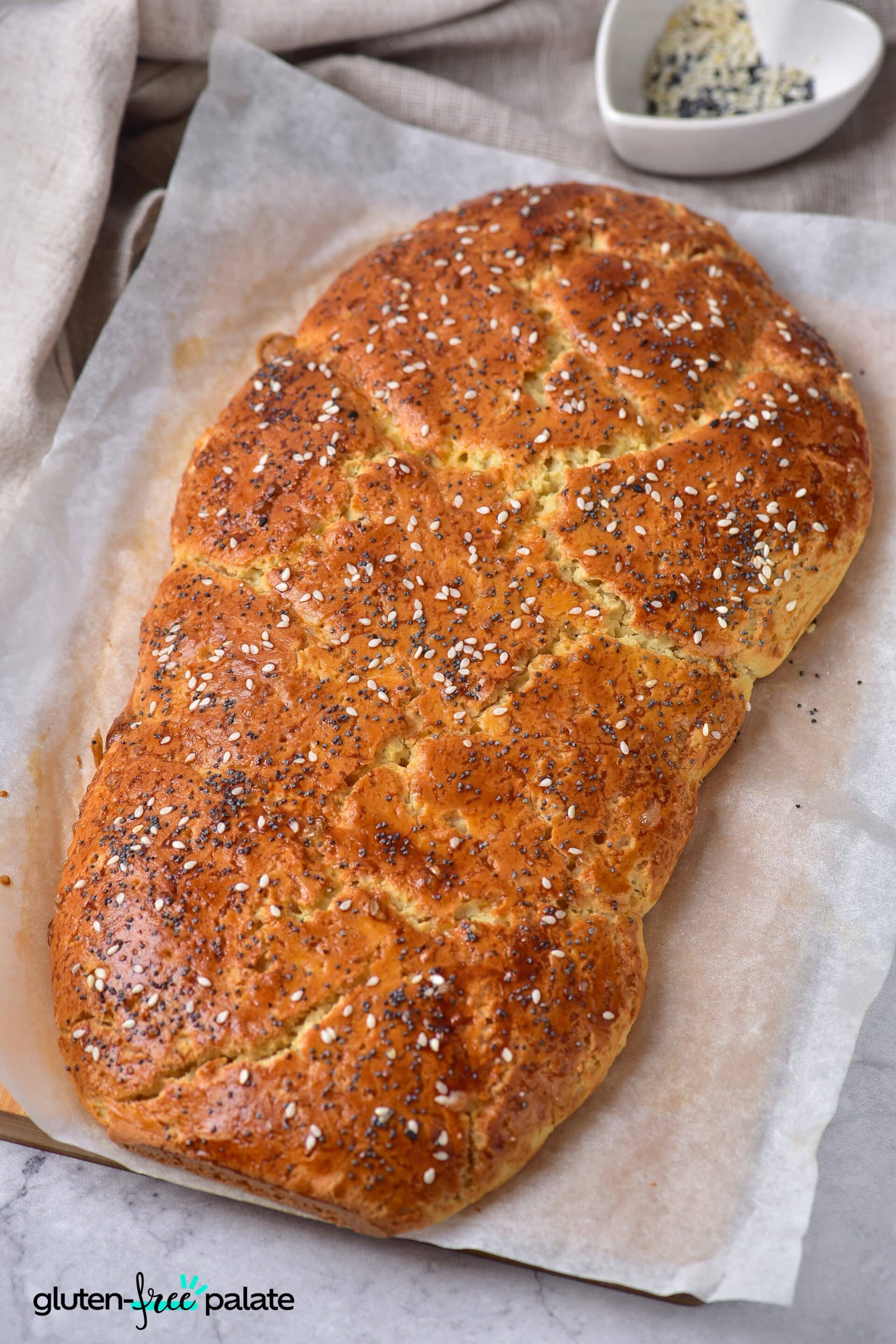 Gluten-Free Challah bread on a baking tray with parchment paper.