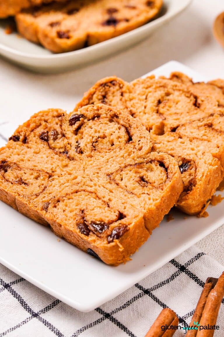 Gluten-Free Cinnamon Raisin Bread on a white plate sliced.