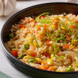 Gluten-free fried rice in a black bowl.