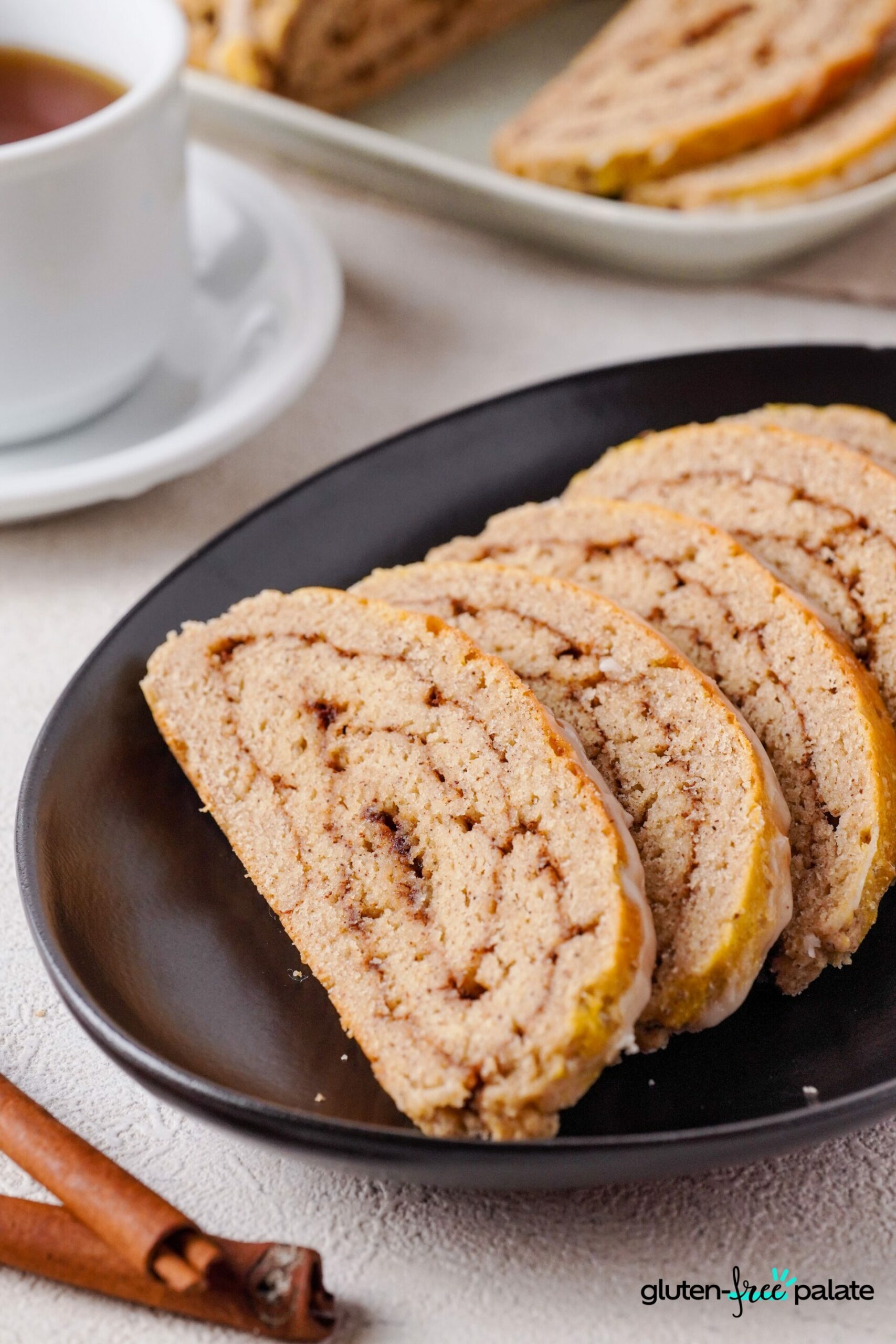 Gluten-Free cinnamon bread sliced on a black plate.