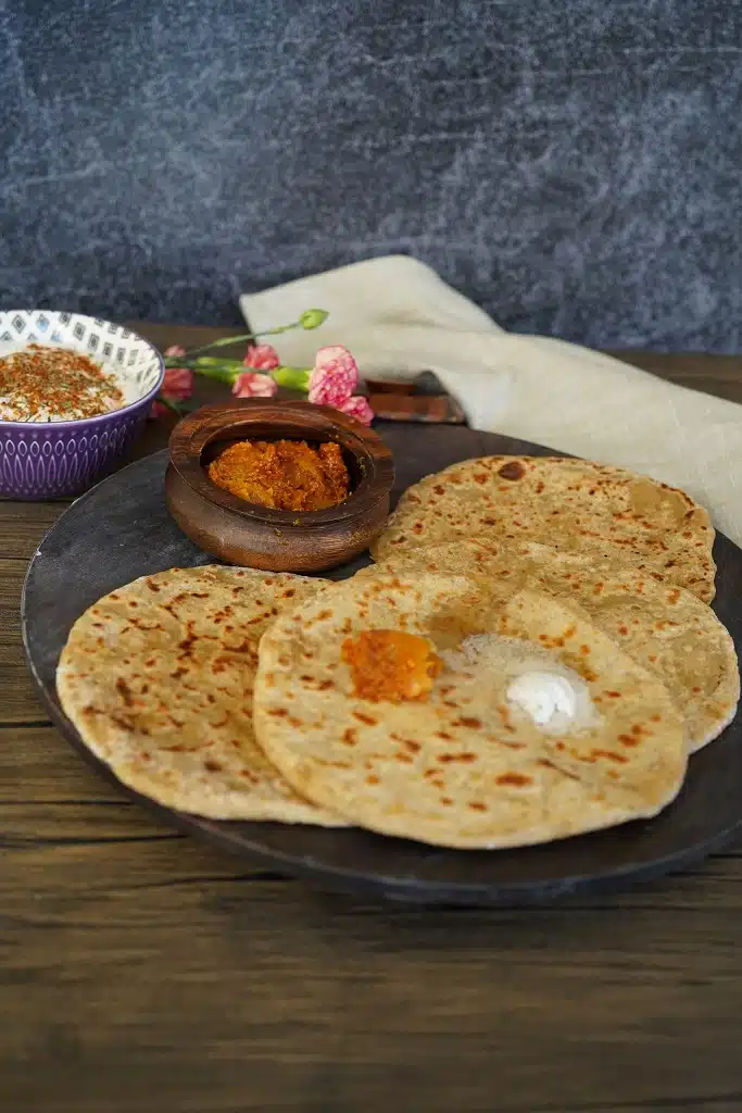 Aloo Paratha in a black plate.