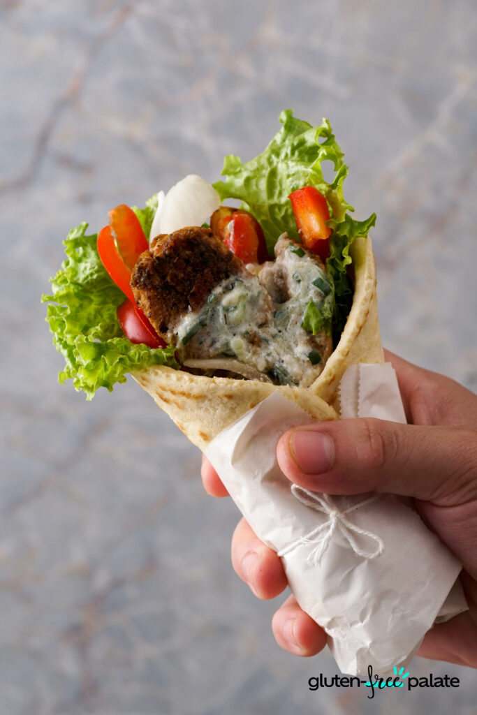 Gluten-Free Gyros being held in a hand.