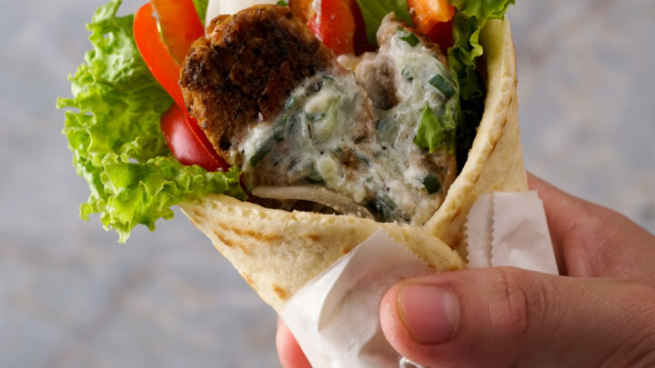 Gluten-Free Gyros being held in a hand.