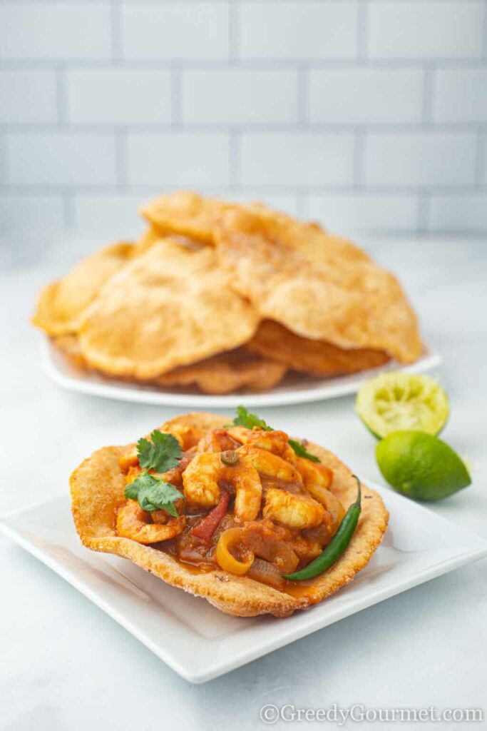 gluten-free puri on a white plate with prawn curry