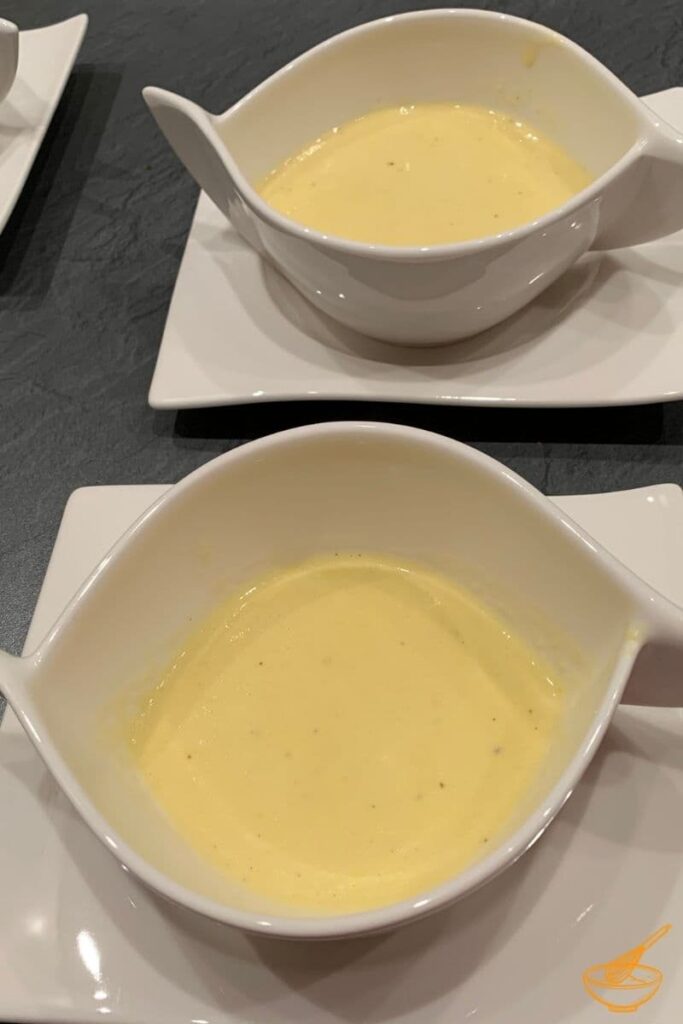 Sweet corn soup in white bowls.