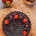 Gluten-free chocolate cheesecake with strawberries on top.