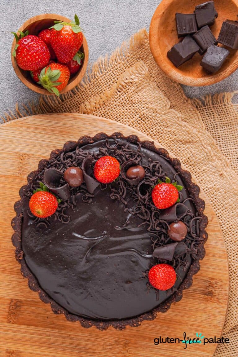 Gluten-free chocolate cheesecake with strawberries on top.