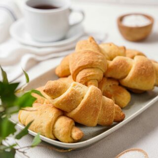 Gluten-Free Crescent rolls on a white plated stacked.