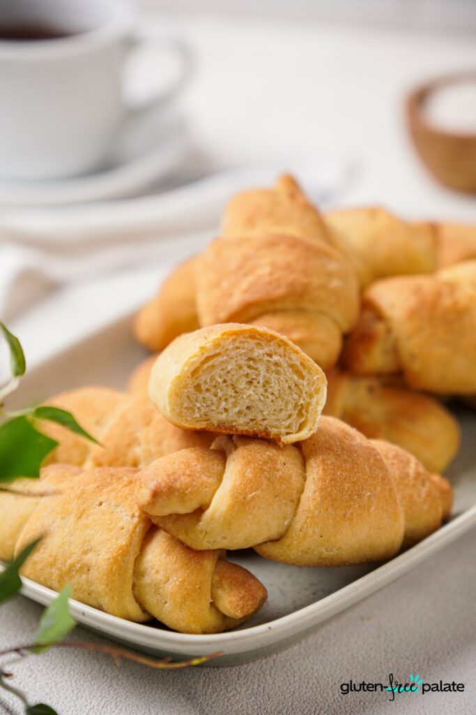 Gluten-Free Crescent rolls on a white plate stacked.