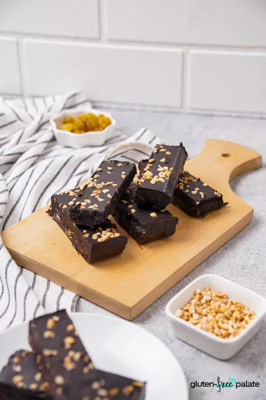 Gluten-Free protein bars stacked on a wooden board.