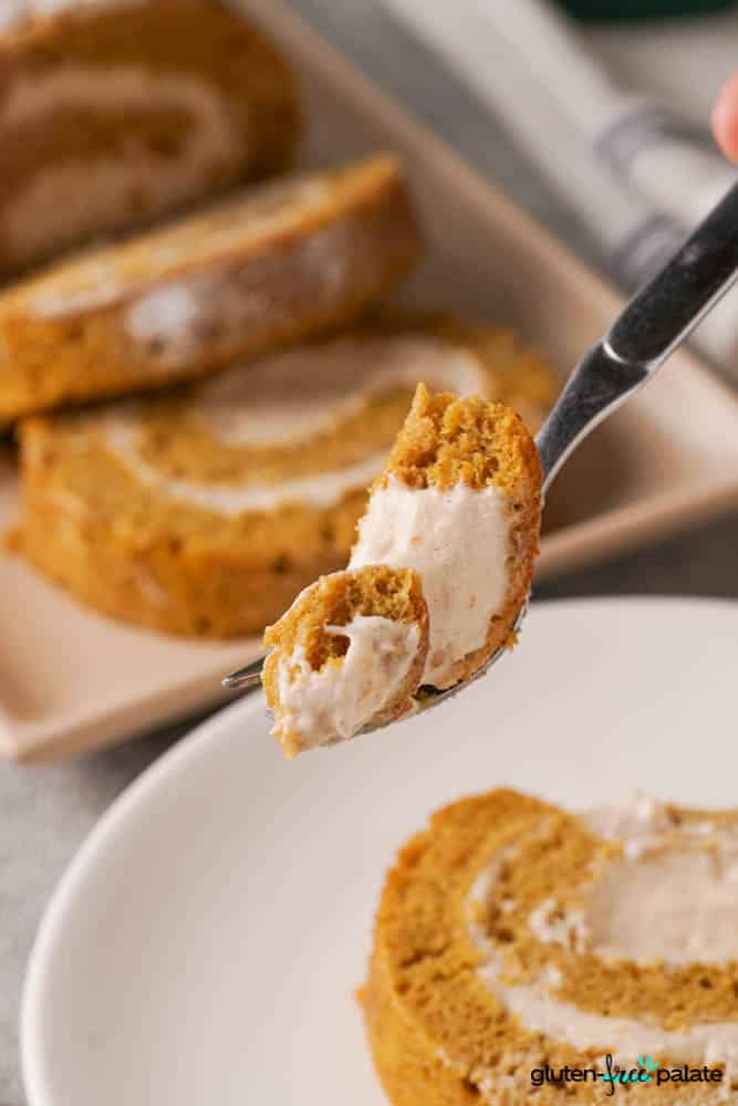 Gluten-Free Pumpkin Roll on a plate with a portion on a fork.