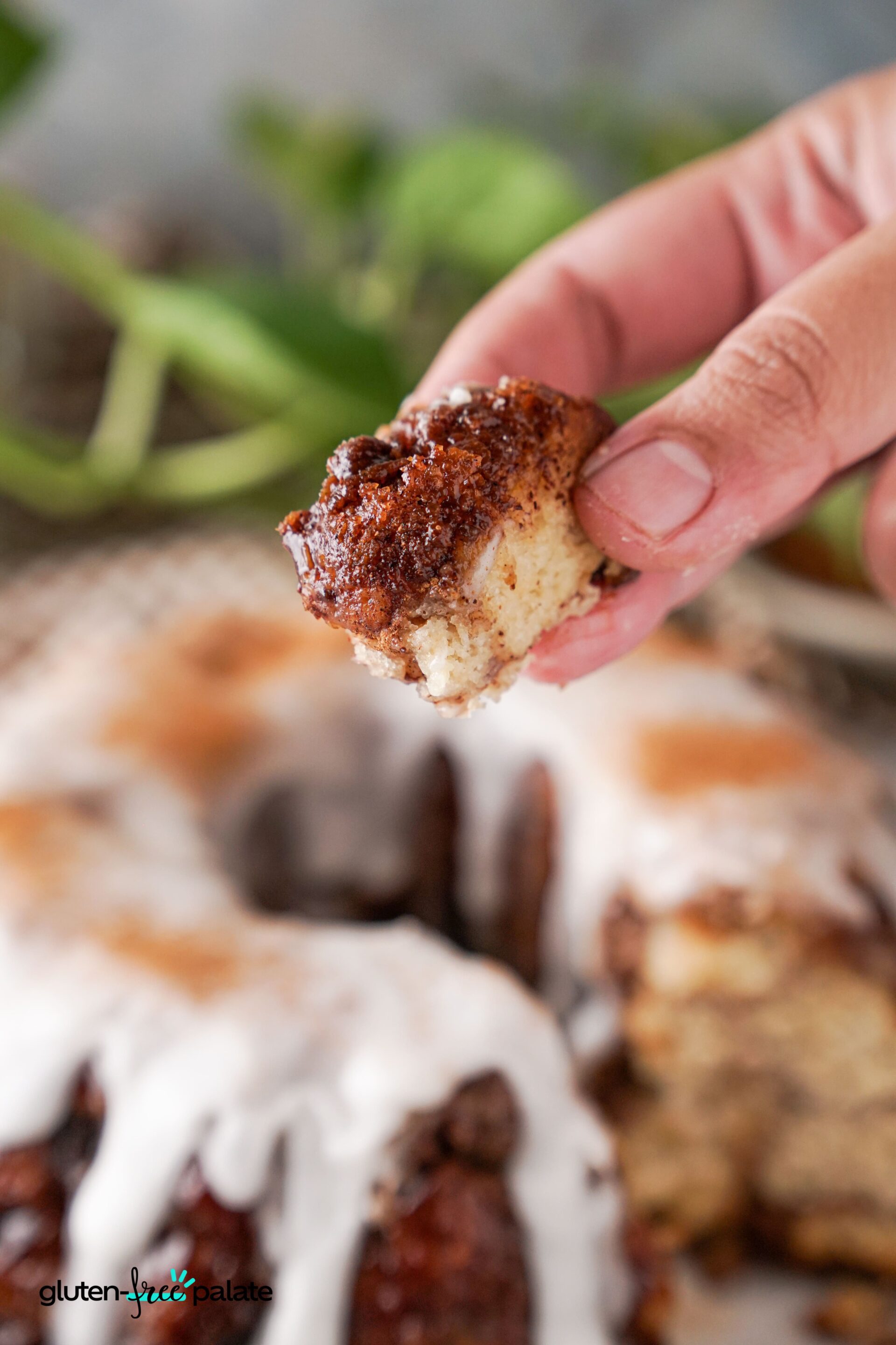 A piece of gluten-free monkey bread being held in a persons hand.