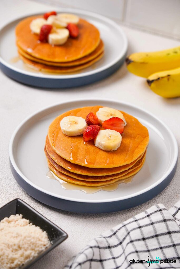 Gluten-Free Protein pancakes on a white plate with toppings.