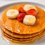 Top down view of Gluten-Free Protein pancakes on a white plate.