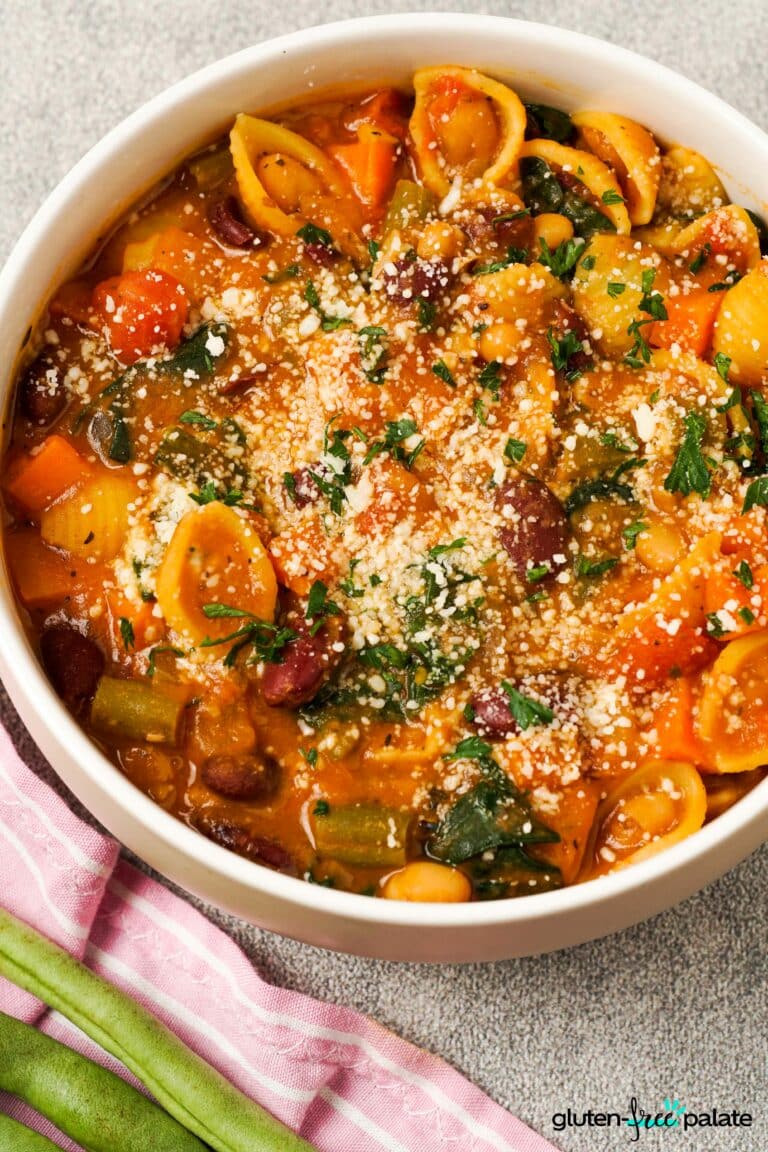 Gluten-Free Minestrone soup in bowls with garnish.