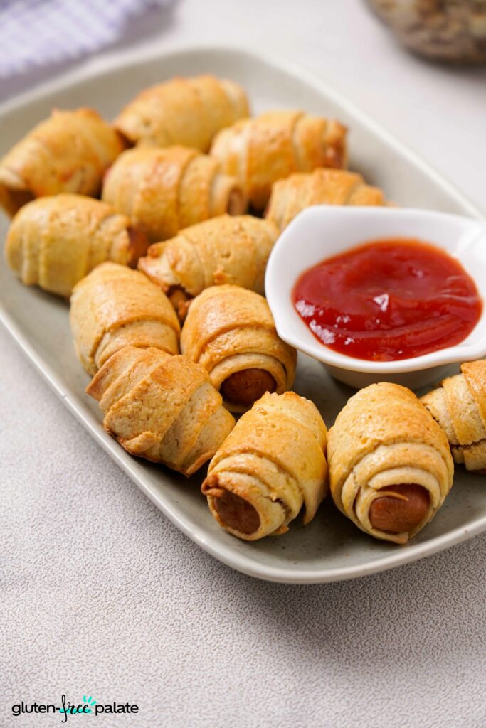 Gluten-Free pigs in a blanket in a white plate.