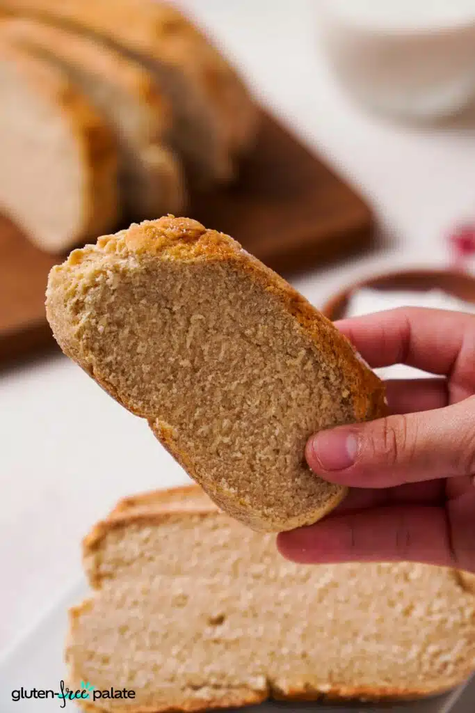Gluten-free Artisan bread being held in a hand showing the texture.