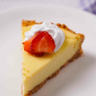 Close up view of Gluten-Free Cheesecake on a white plate.