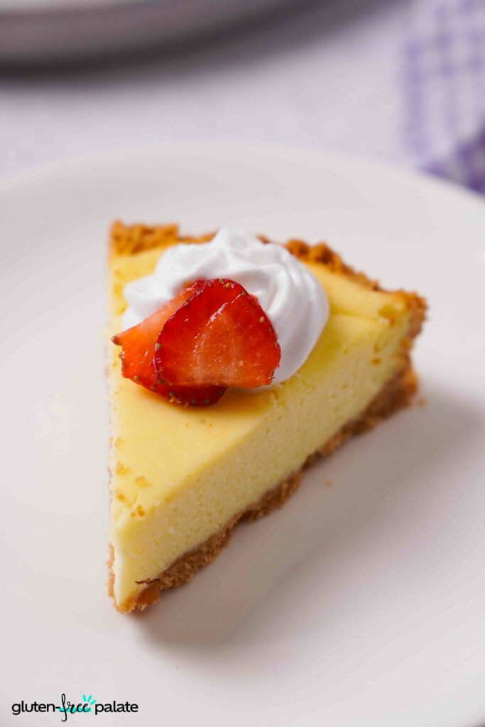 Close up view of Gluten-Free Cheesecake on a white plate.