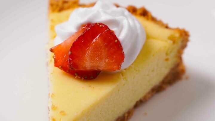 Close up view of Gluten-Free Cheesecake on a white plate.