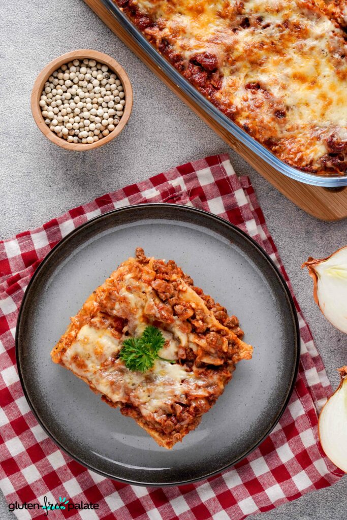 Gluten-free lasagna in a plate with a casserole dish.