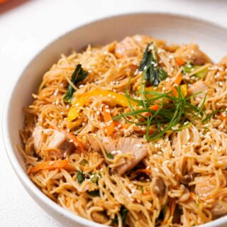 Zoomed in view of Gluten-Free Lo Mein in a white bowl, showing the ingredients.