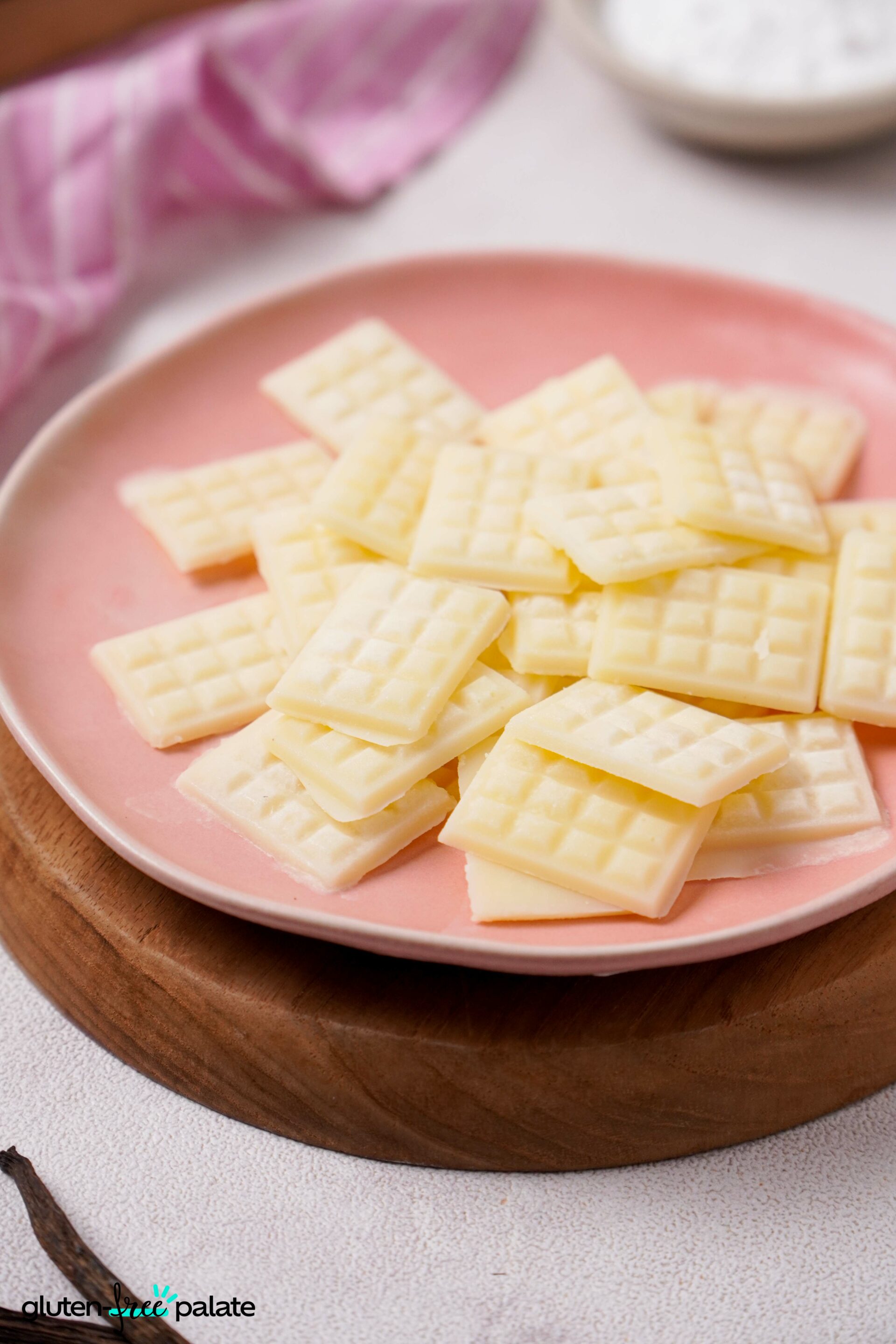 Close up view of Vegan White chocolate on a pink plate.