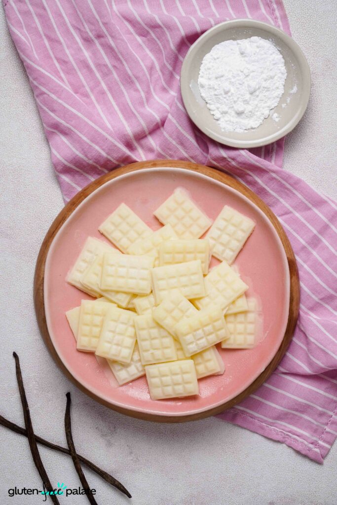 Vegan White chocolate on a pink plate.