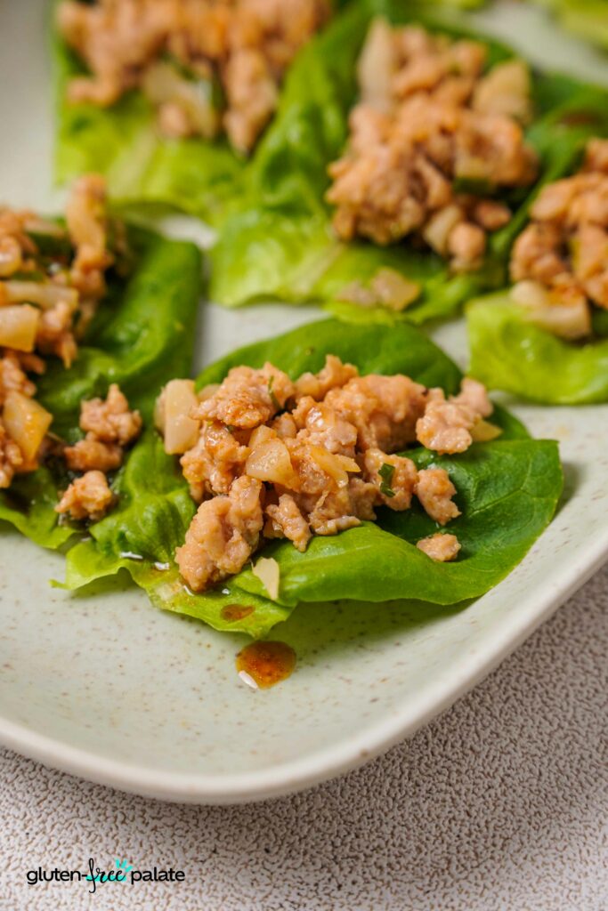Close up view of Gluten-Free Lettuce Wrap on a white plate.