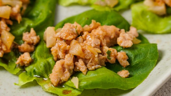 Close up view of Gluten-Free Lettuce Wrap on a white plate.