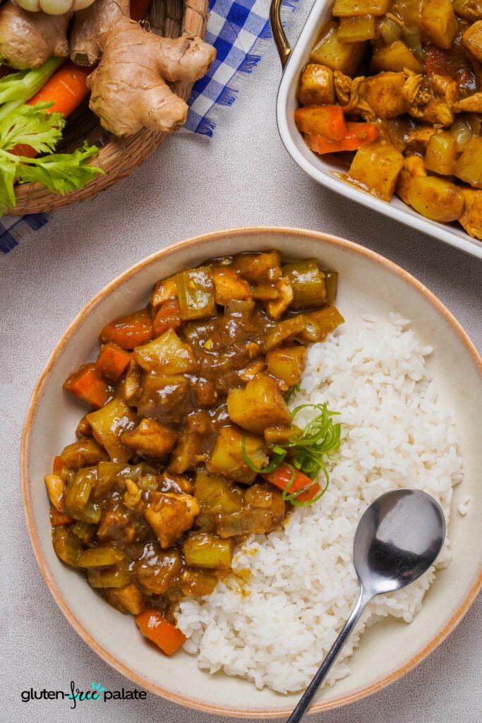 Close up view of Gluten-Free Japanese Curry in a bowl with rice and a spoon.