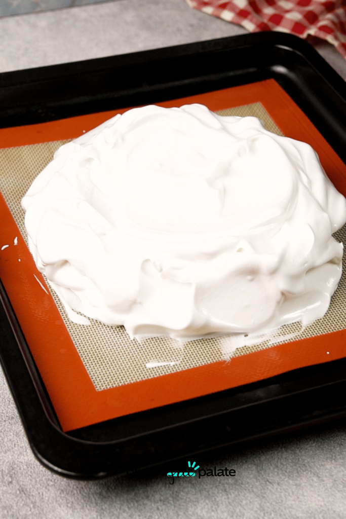 Transfer the meringue to the baking sheet. Make sure the edges are tall, so you'll be able to properly add toppings.