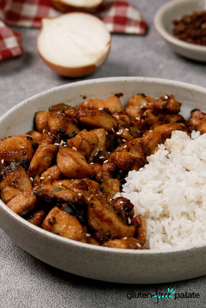 A bowl of Mala Chicken, served with rice.