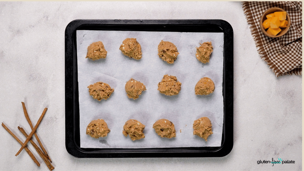 Once everything is mixed, spoon out spheres of cookie dough onto a baking sheet.