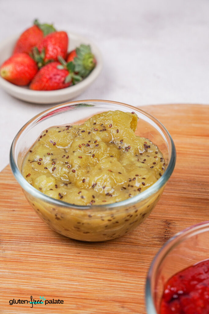 A close-up of a small glass bowl filled with green kiwi compote.