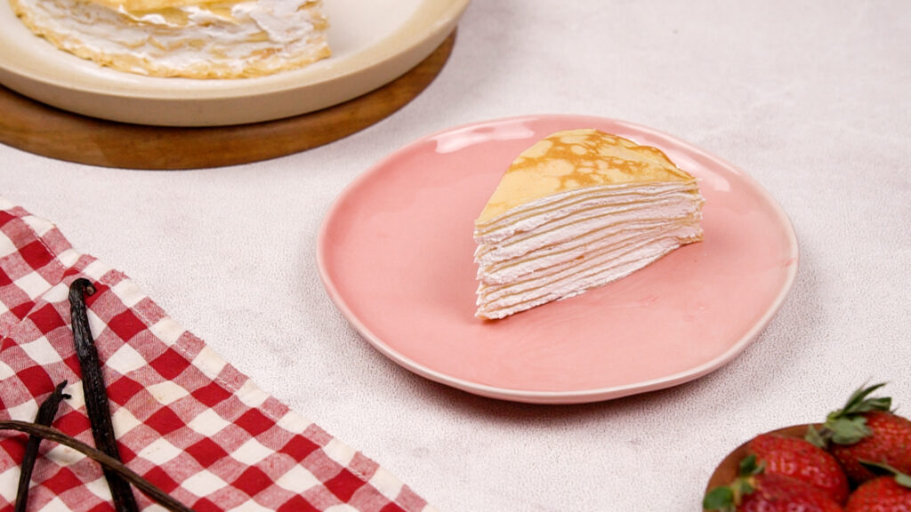 Mille crepe cake slice on a pink plate. Photo by Gluten-Free Palate.