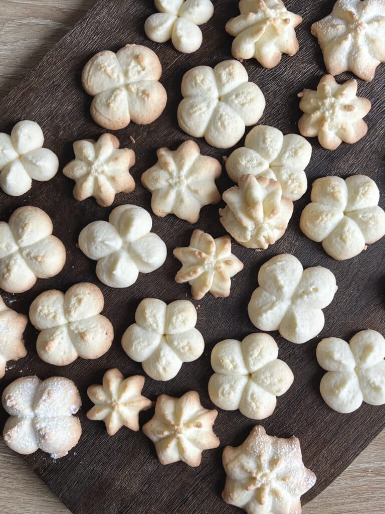 An assortment of Christmas spritz cookies on a board.