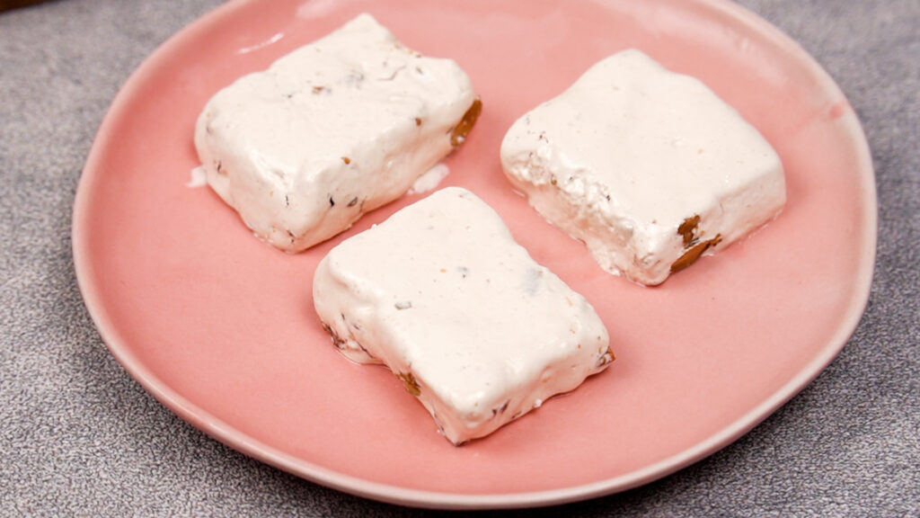 Sliced nougat in a pink plate.