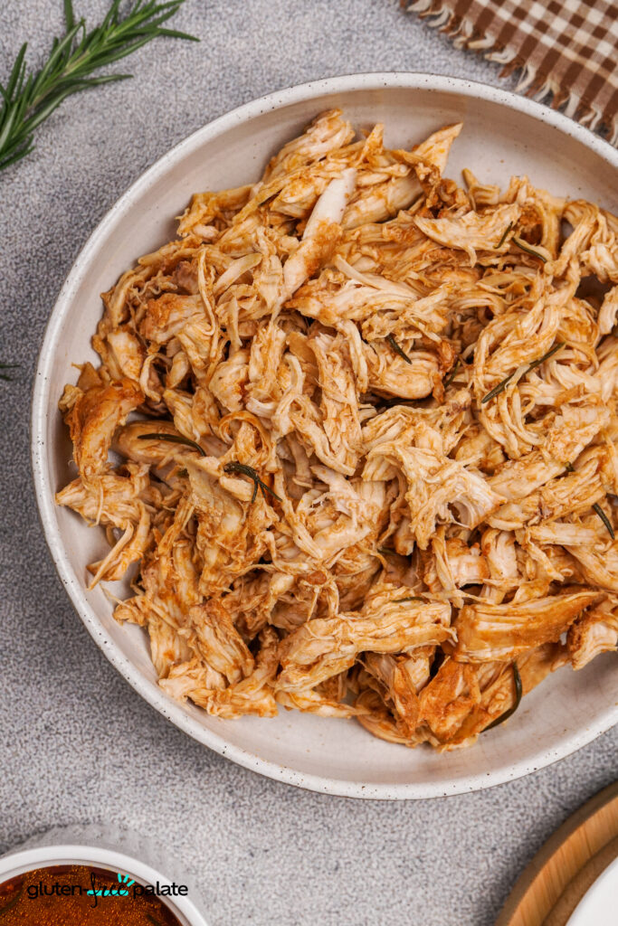 Shredded Barbecue Chicken in a Bowl A bowl filled with cooked and shredded barbecue chicken.