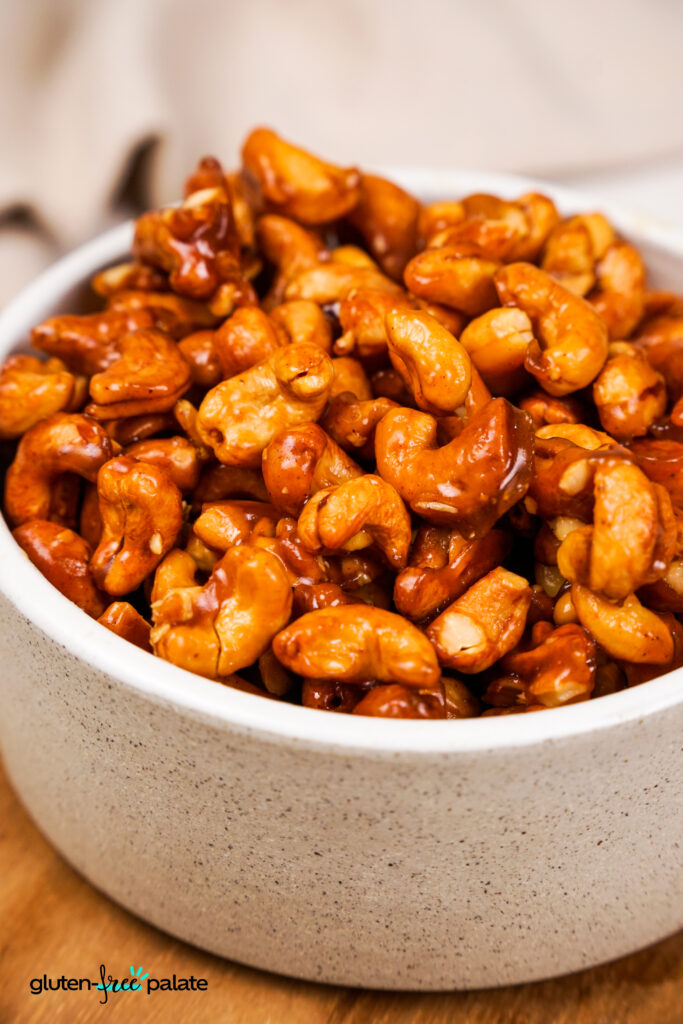A bowl with golden-brown honey-roasted cashews.