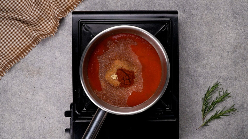 Step 2 A saucepan filled with BBQ sauce, brown sugar, and spices, ready to be combined into a rich, tangy base.