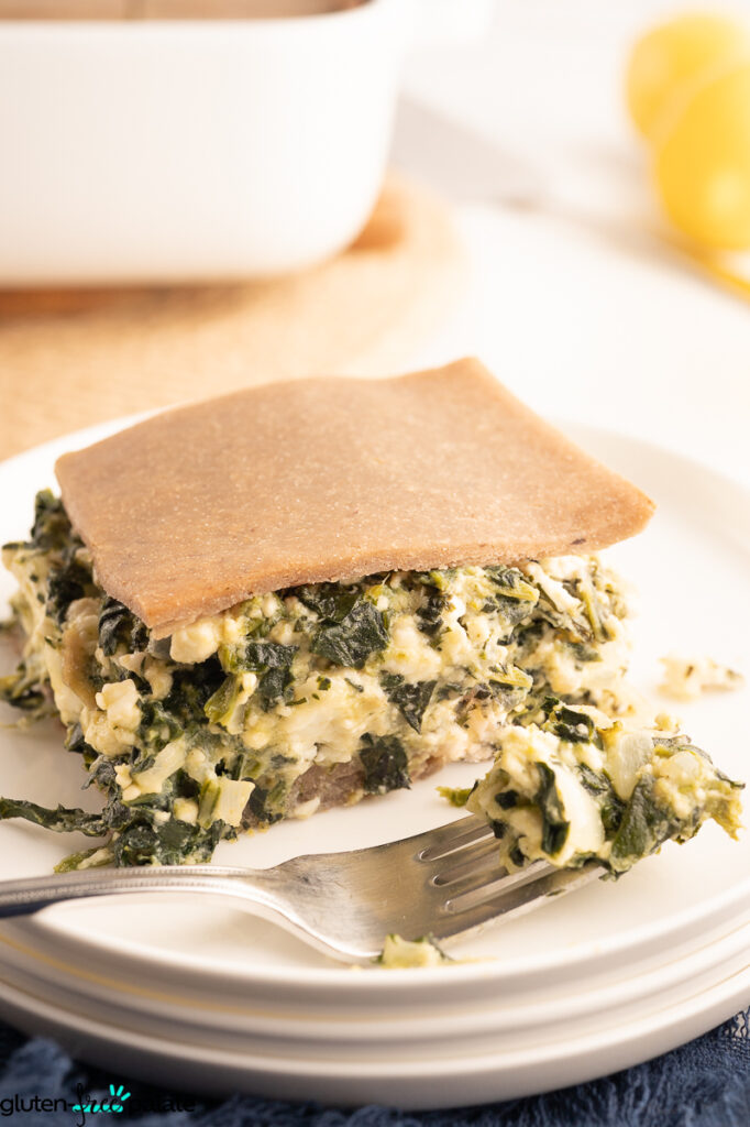 ¾ view of Gluten-Free Spanakopita showing the gluten-free phyllo crust and the filling of spinach, dill and feta cheese.