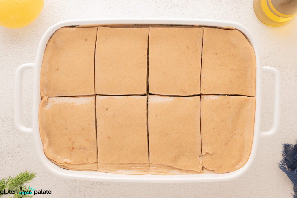 Casserole being sliced and ready to bake.